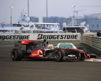 Formula 1 cars race on the track at the Abu Dhabi Grand Prix, highlighting the speed and competition of the event.