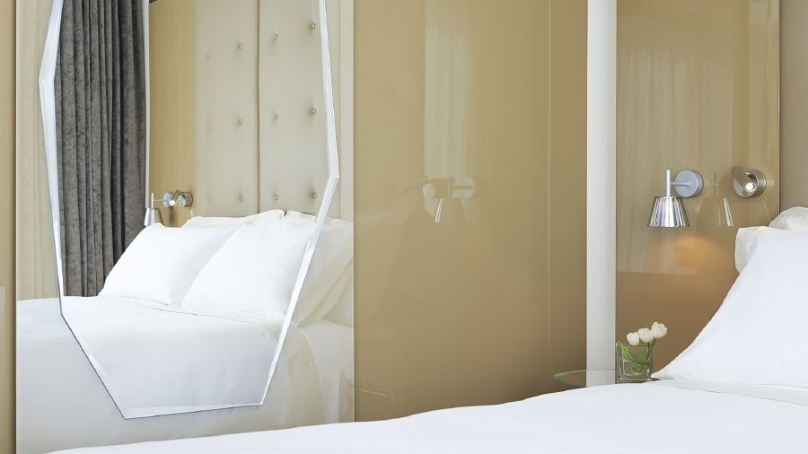Elegant hotel room featuring two beds with plush bedding, classic furniture, and a soft, inviting color palette, perfect for Indy 500 accommodations in Indianapolis, Indiana.