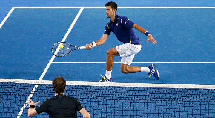 Two male tennis players in action during a match at Melbourne Park, with one preparing to volley at the net, reflecting the competitive spirit of the Australian Open.