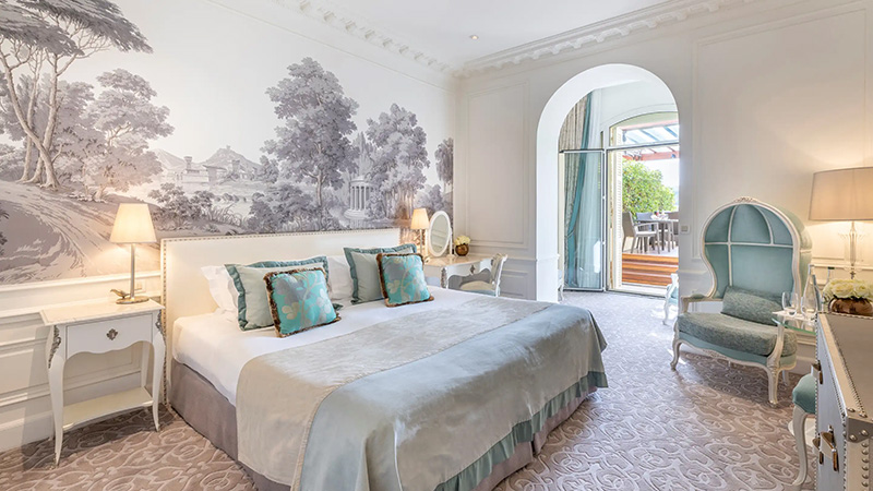 Luxurious bedroom in Hotel Hermitage, Monaco, featuring elegant decor and balcony access, ideal for Monte Carlo and Monaco Grand Prix visitors seeking premium accommodations.
