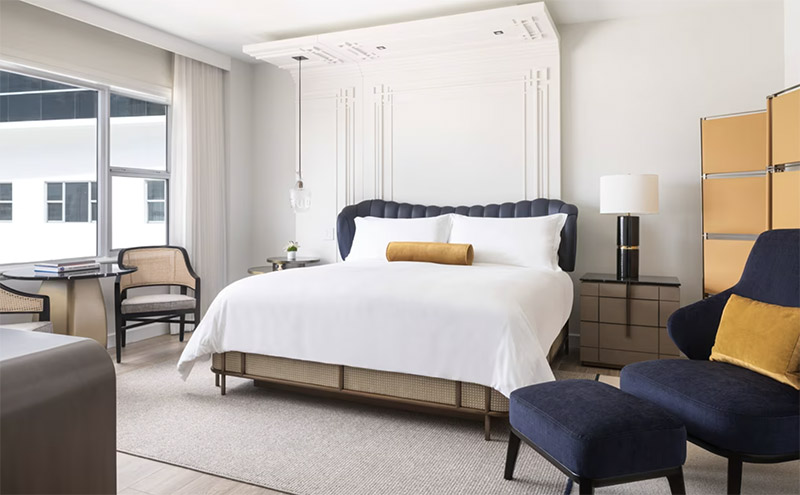 Luxurious hotel room at The Ritz-Carlton, South Beach featuring a plush king-sized bed, elegant furniture, and a soothing color palette, ideal for guests visiting Miami Beach for the Club World Cup.