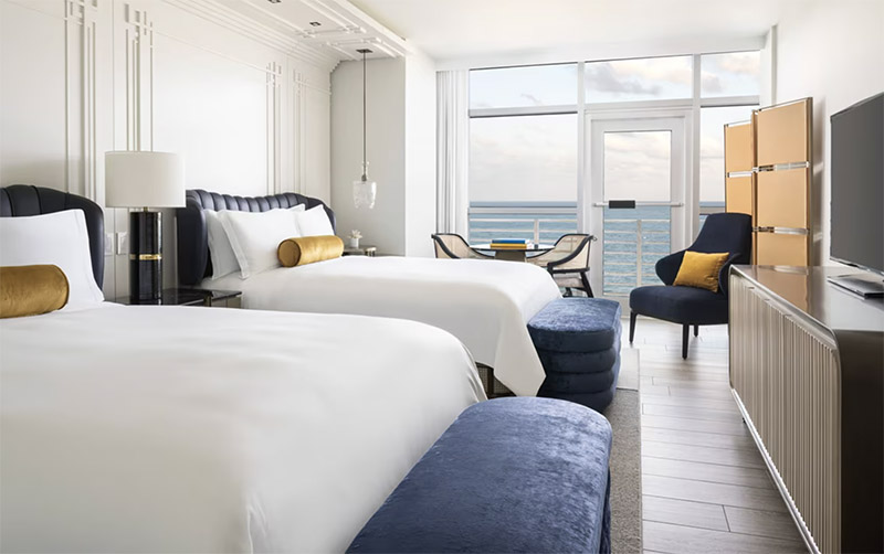 Luxurious double room at The Ritz-Carlton, South Beach, showcasing two beds with ocean views, ideal for visitors attending the Club World Cup in Miami and New York.