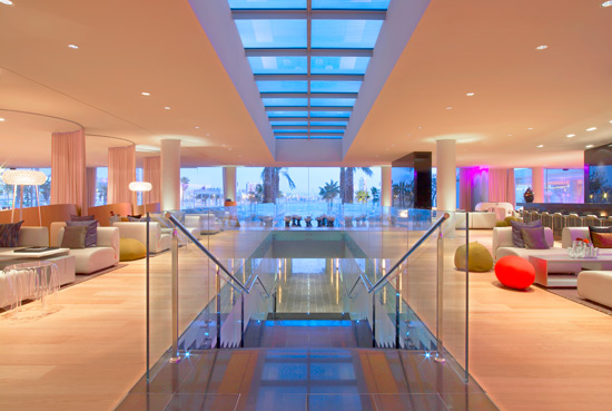 Luxurious hotel lobby in Barcelona featuring modern design, vibrant lighting, and stylish furniture, ideal for accommodations at the Spanish Grand Prix.