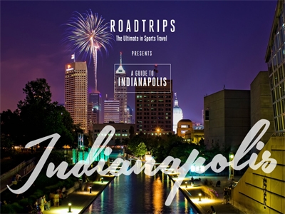 Fireworks illuminate the night sky above downtown Indianapolis, complementing a promotion for a luxury travel guide by Roadtrips, focusing on sporting events and the city's attractions.
