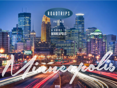 Evening view of Minneapolis skyline with illuminated buildings and busy traffic, promoting a luxury travel guide by Roadtrips.